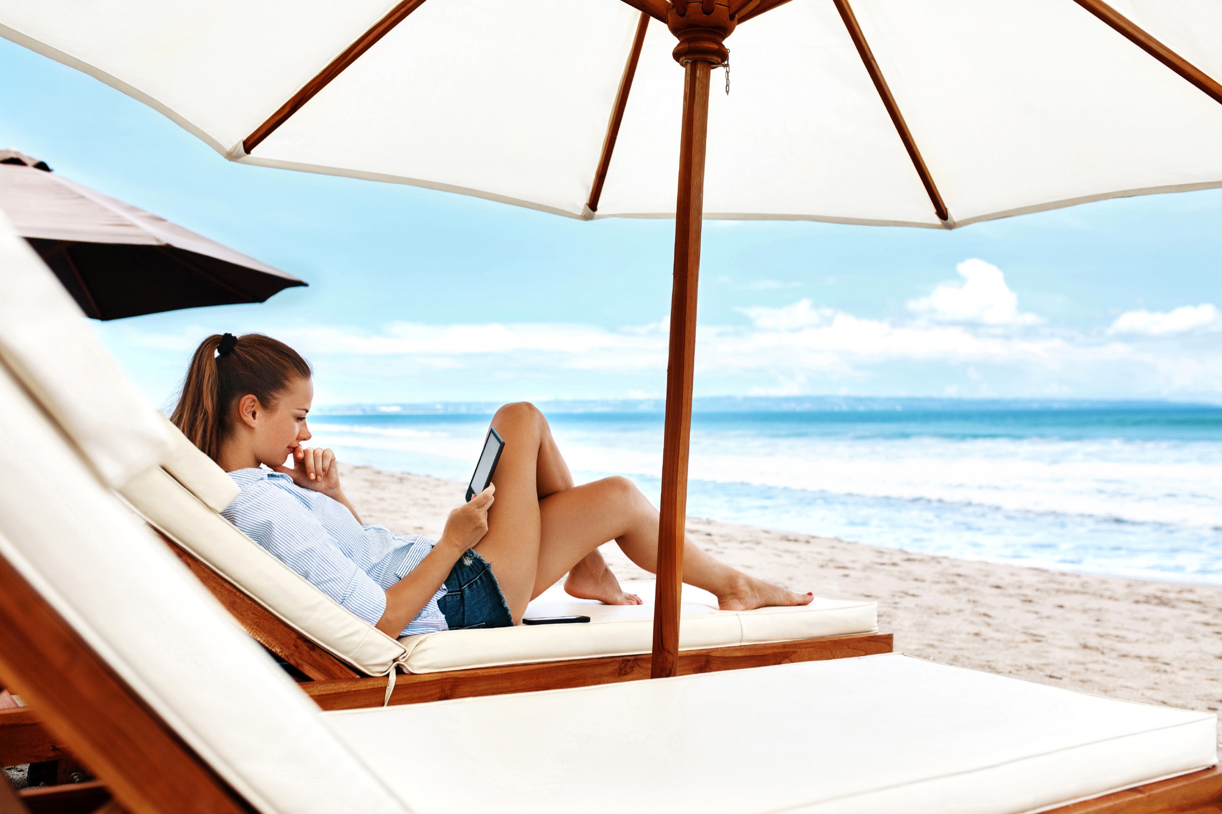A resident relaxes by the sea at the Wyndham Residences resort on Al Marjan Island